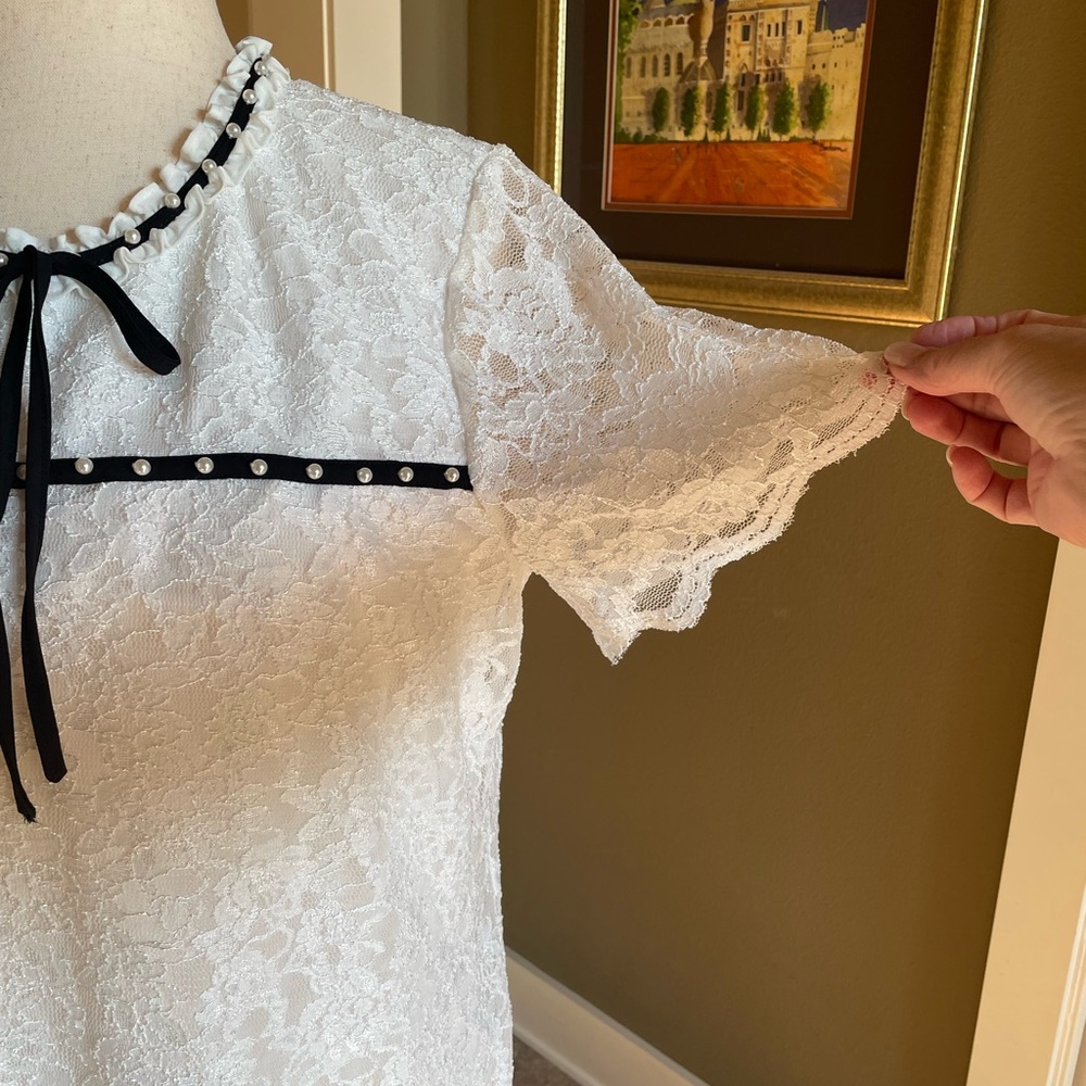 White lace blouse with pearls and black trim by Karl Lagerfeld. New with tags